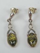 A pair of silver and green baltic amber stud earrings, approx 2.9cm in length. In presentation box.