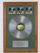 A framed record montage for The Beatles