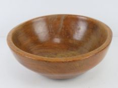 A turned wooden fruit bowl, 30cm dia.