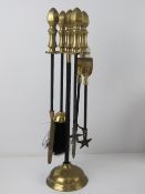 A brass and black painted metal fireside