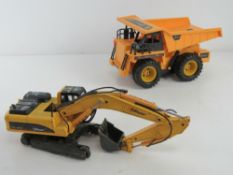 Two 'Top Race' toys, one being a metal digger,