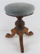 A piano stool having circular padded sea