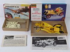 A Fokker E-III Revel scale model kit together with a Highway Classics Hup mobile scale model.