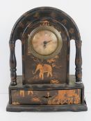 A contemporary mantle clock decorated with elephants having drawer under and standing 28.5cm high.