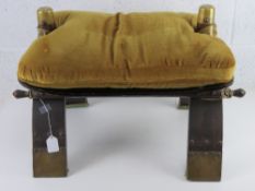A c1970s camel saddle stool having brass