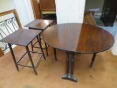 A mahogany drop leaf oval table raised o