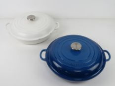 Two LeCruset casserole dishes in blue an