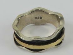 A silver 'worry' ring having single yell