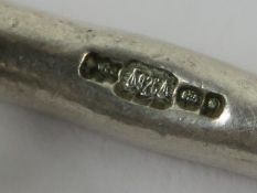 An HM silver charm bracelet having T-bar