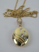 A silver and gold plated locket having f