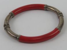 A silver and red enamel bangle, stamped