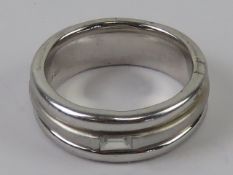 A hallmarked silver ring having baguette
