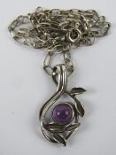 An amethyst and silver pendant of floral