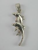 A silver pendant in the form of two leap