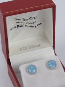 A pair of silver and opal stud earrings,
