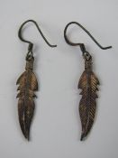 A pair of silver feather earrings, stamp
