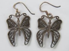 A pair of silver filigree earrings in th