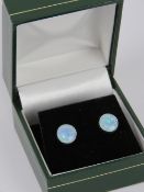 A pair of silver and opal stud earrings,