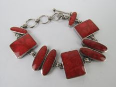 A silver and faux coral bracelet, oval a