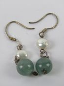 A pair of green jade and pearl earrings,