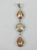 A triple citrine pendant having round an
