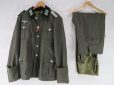 A reproduction WWII German Combat Tunic (XXXL) and breeches.