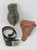 A German water bottle, together with a WWII German holster and a German belt and belt buckle.