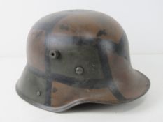 A reproduction M16 camo helmet with liner.