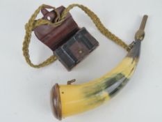 A powder horn and leather ammo pouch.