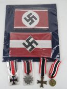 A quantity of assorted reproduction militaria; 2x German Armbands. 4x German Medals.