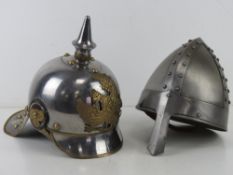 Two reenactors helmets being; Prussian M1867 Cuirassier Cavalry and Norman soldier.