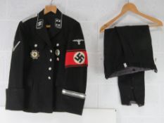 A reproduction WWII German SS tunic with Insignia and trousers.