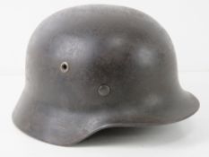 A WWII German Luftwaffe helmet with liner and part of the decal present.