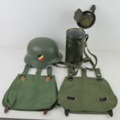 An assortment of reproduction German military items inc; helmet, two bread bags,