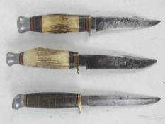 Three assorted fighting knives, two having antler handles.