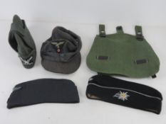 A quantity of reproduction militaria; 3x German sidecaps. 1x German 43 cap. 1 x German bread bag.