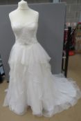 A wedding dress by David Bridal, size 14, in need of dry cleaning.