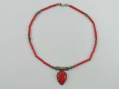A silver and faux coral necklace having