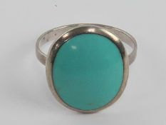A silver and turquoise ring, stamped 925