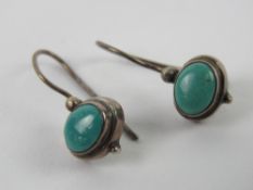 A pair of turquoise earrings, no apparen