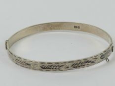 A HM silver hinged bangle having floral