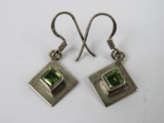 A pair of silver and peridot square shap