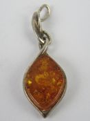 A Baltic amber and silver pendant, stamp