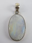 A large oval moonstone cabachon set in w