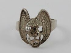 A silver ring of Gothic form being a vul