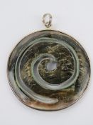 A circular mother of pearl pendant with