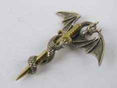 A silver dragon and sword pendant, stamp