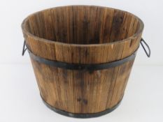 A coopered oak barrel planter having twi