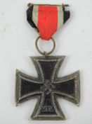 A reproduction WWII German Iron Cross with ribbon.