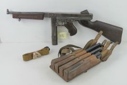1x Thompson M1A1 S/N 206506, plus sling, 3 spare magazines, mag pouch, and 5 inert rounds.